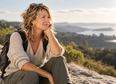 Maureen sitting on a hilltop overlooking the water